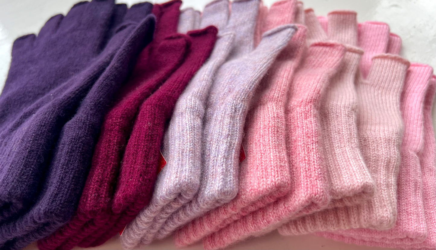 all the shades available in pink and purple cashmere fingerless gloves showing the rib cuff details
