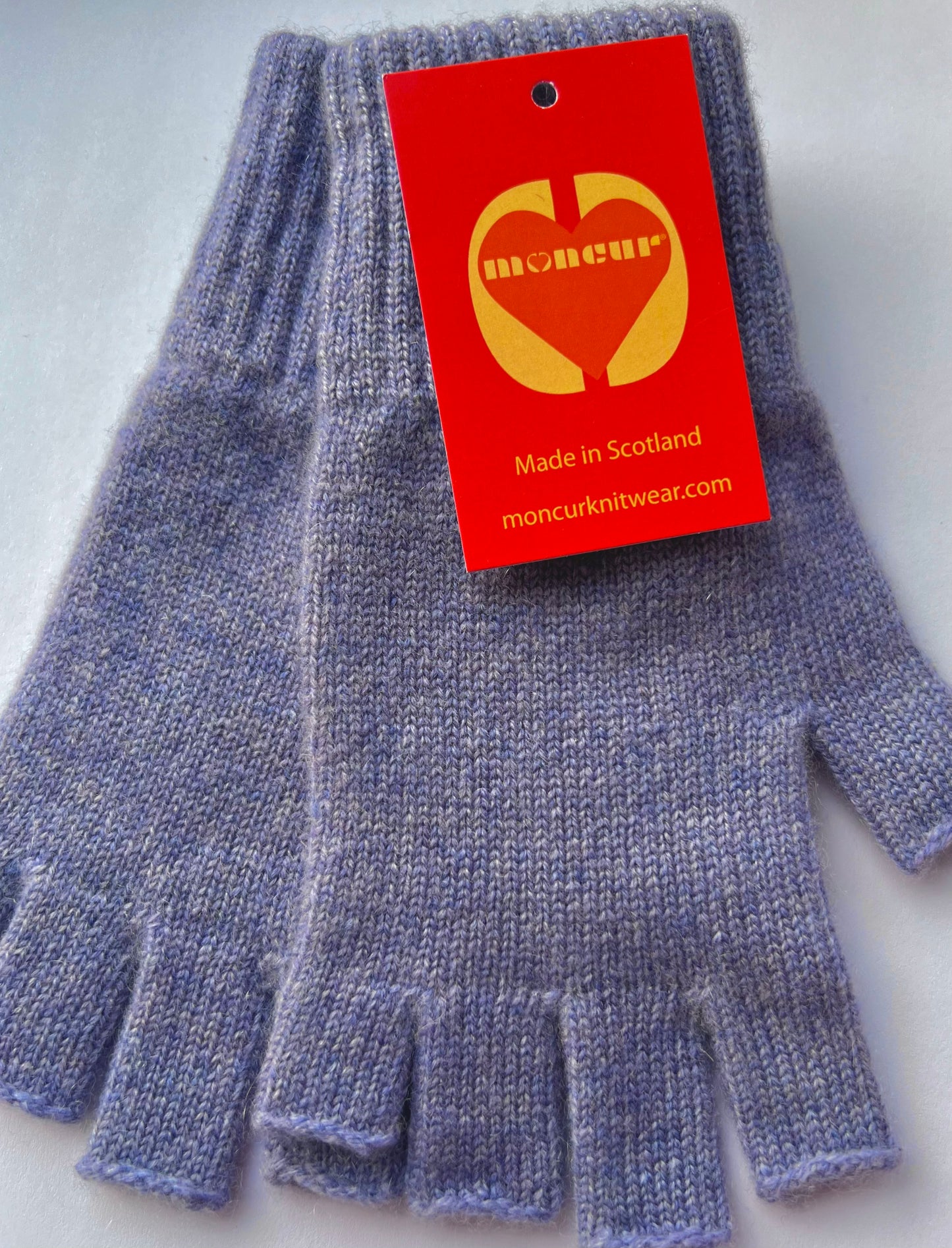 lilac haze cashmere fingerless gloves by moncur knitwear displayed flat with orange heart logo branding 