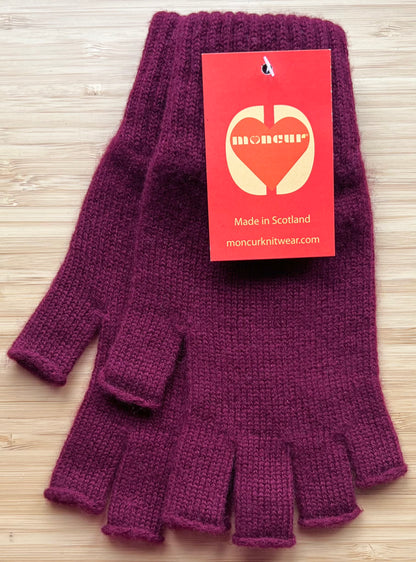 A pair of burgundy cashmere fingerless gloves  with tags indicating the brand Moncur Knitwear.