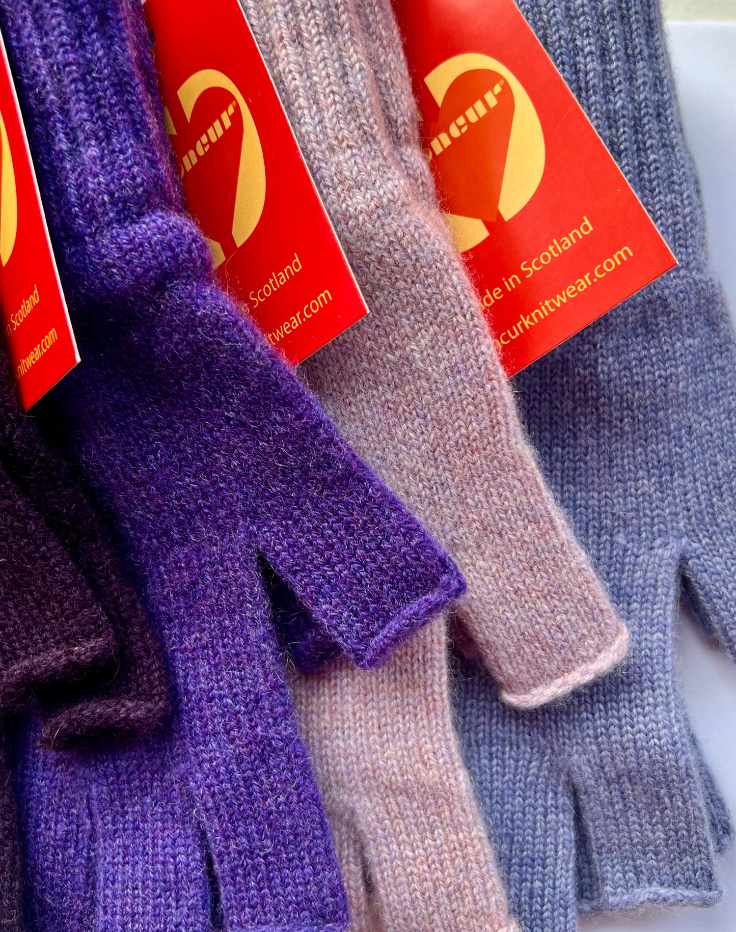 close up of colours available in the purple shades of the cashmere fingerless gloves by moncur knitwear