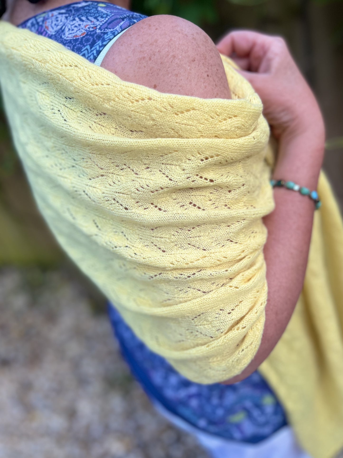 lemon lace wrapped around shoulders to show how it can be worn in summer 