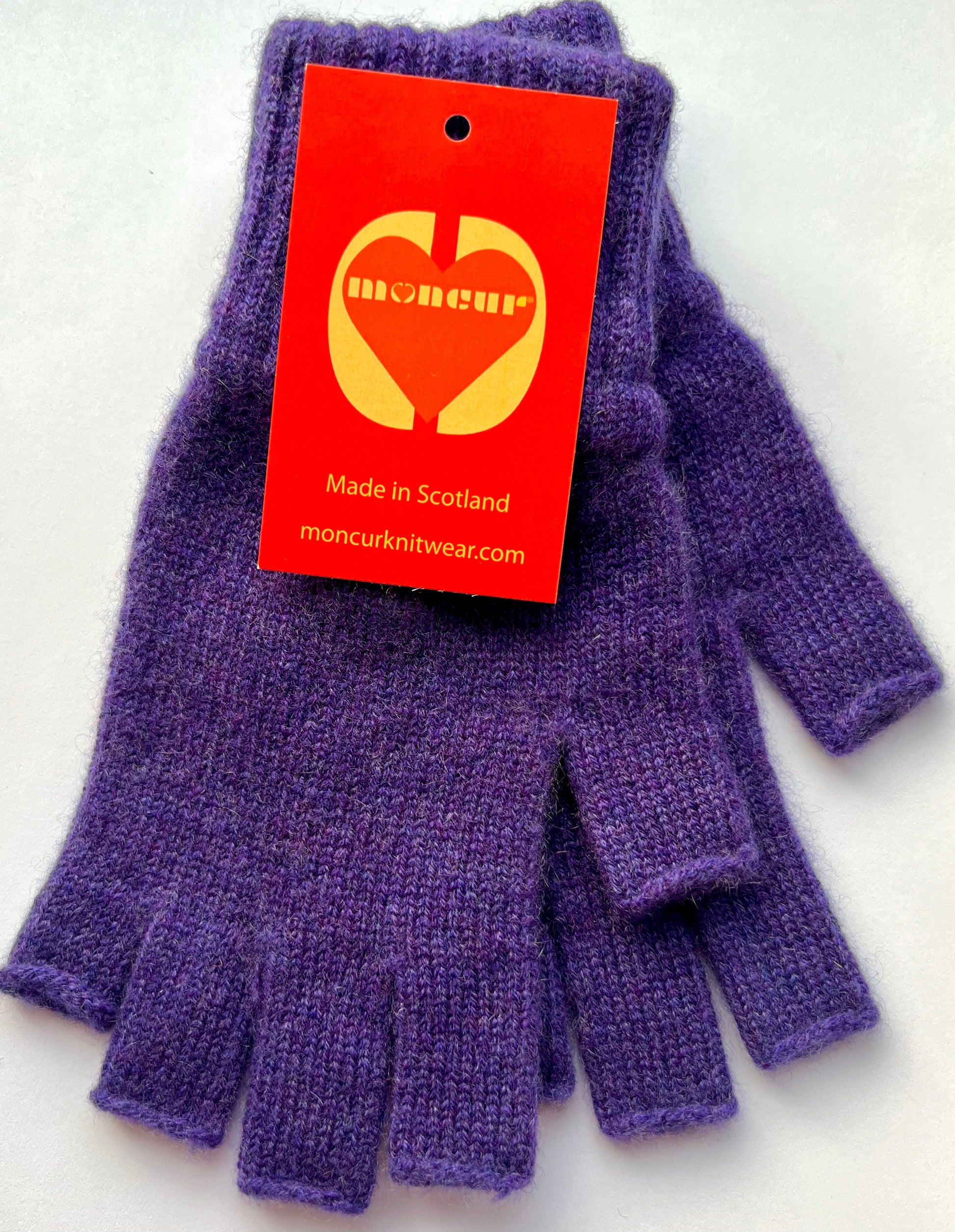 flat lay picture of regal purple shade of cashmere fingerless gloves by moncur knitwear 